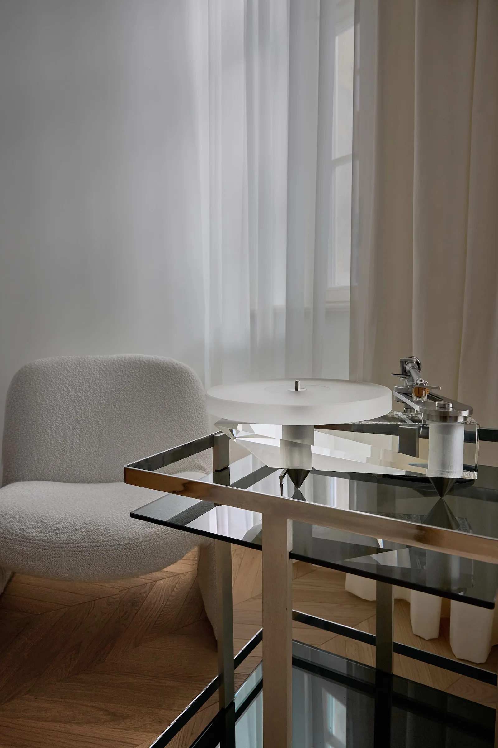 Show apartment 2+kk — record player and armchair by the window