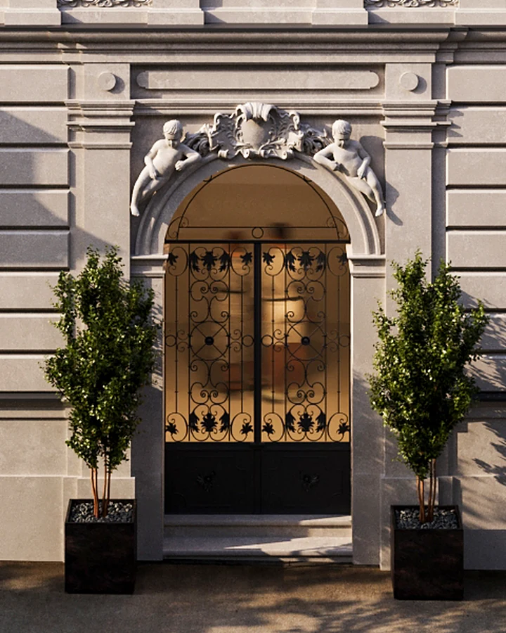 Entrance portal with sculptural decoration and wrought-iron gate